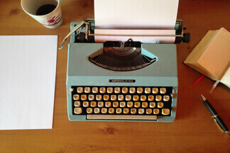 Bird's eye view of a desk with old typewriter.