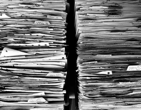 Close up of two large stacks of paper standing opposite each other