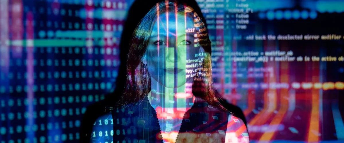 Codes are projected onto a young woman.